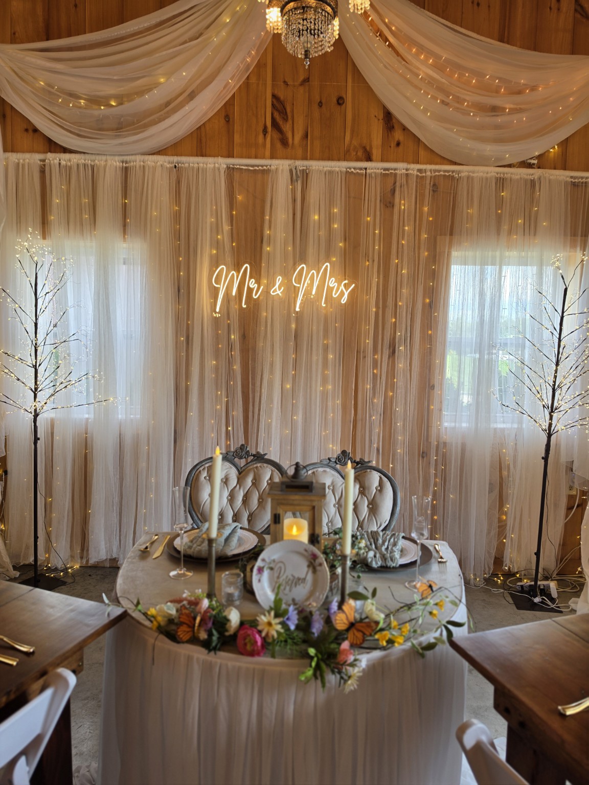Elegant wedding reception backdrop with warm lights and draping